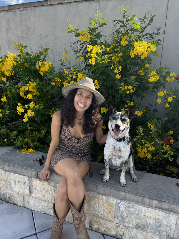 Carmina with white dog, yellow flower background (landscape)